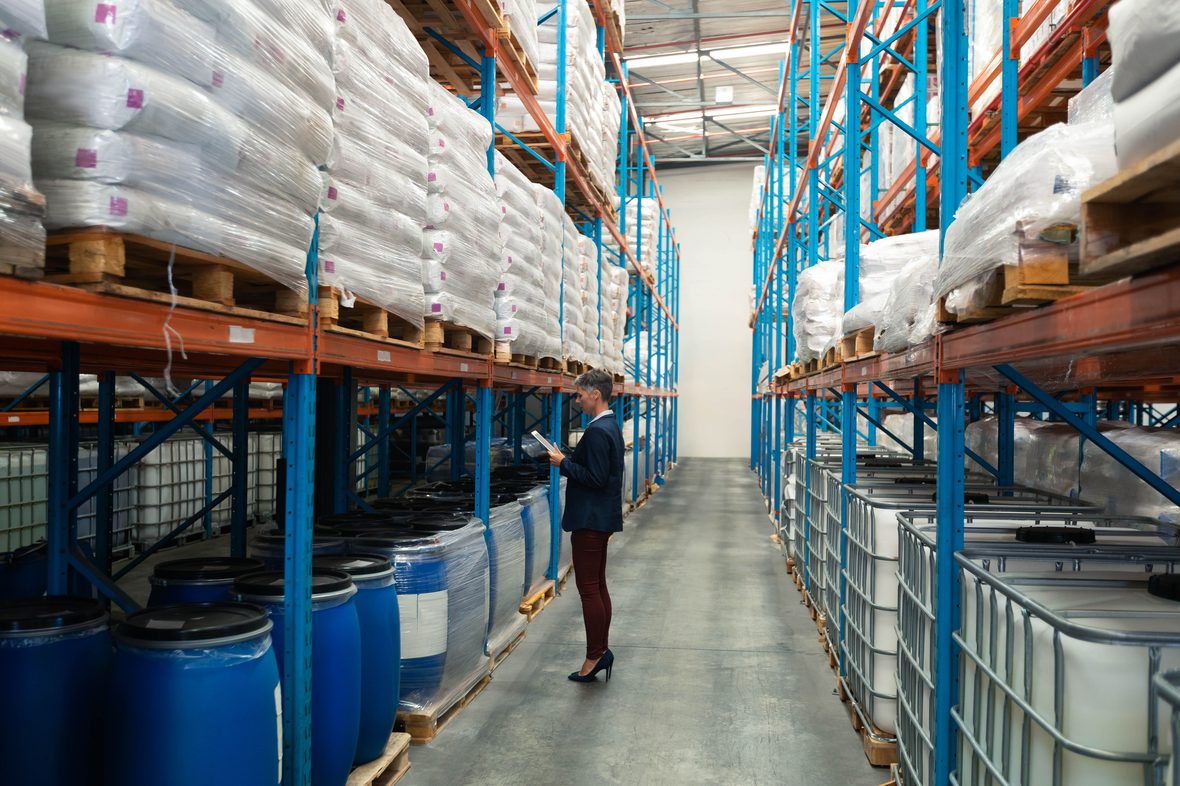 Inventory specialist reviewing chemical stock in the warehouse