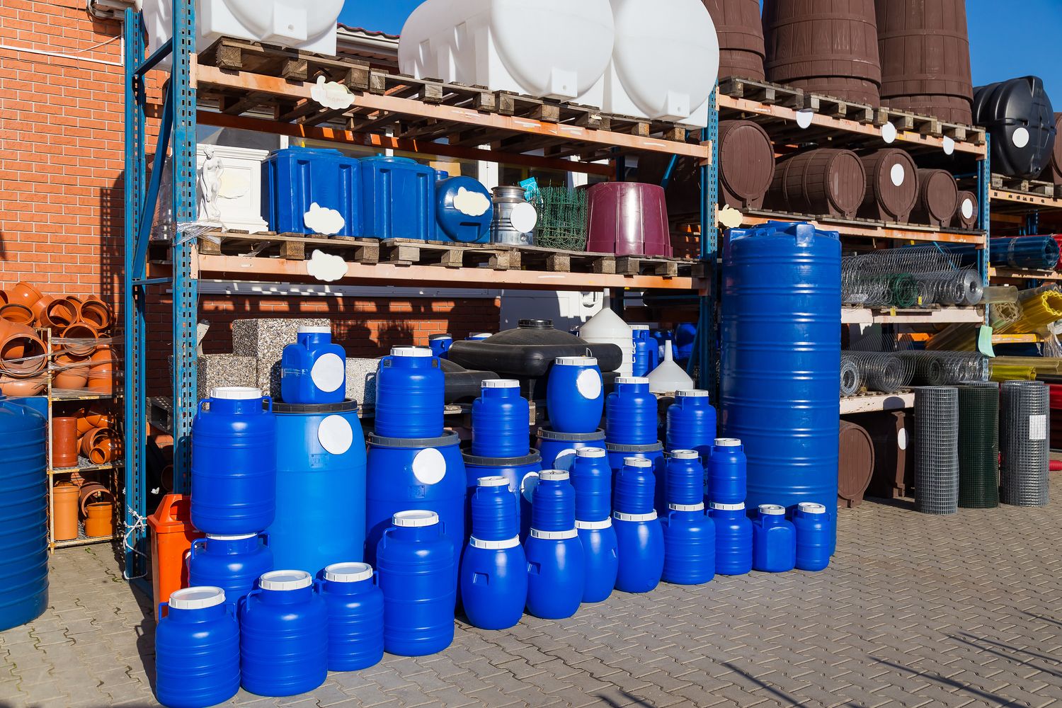 Storage barrels and containers on warehouse shelving